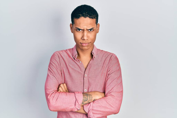 Young african american guy wearing casual clothes skeptic and nervous, disapproving expression on face with crossed arms. negative person.  - Foto, imagen