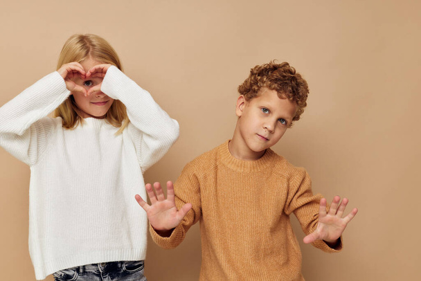 Cute stylish children standing next to posing emotions isolated background - Foto, afbeelding