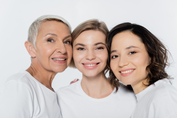 Portrait of positive women looking at camera isolated on grey  - Foto, Bild