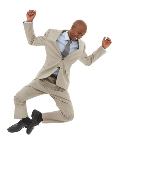 Floating on success. An African-American businessman jumping joyfully in the air. - Fotoğraf, Görsel