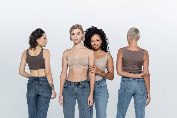 Multiethnic women in tops posing on grey background  - Fotografie, Obrázek