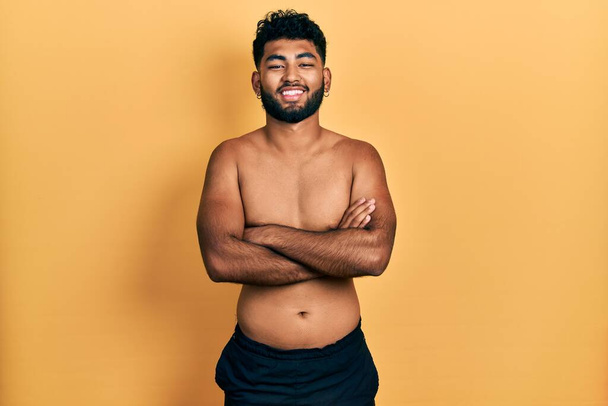 Arab man with beard wearing swimwear shirtless happy face smiling with crossed arms looking at the camera. positive person.  - Foto, Bild