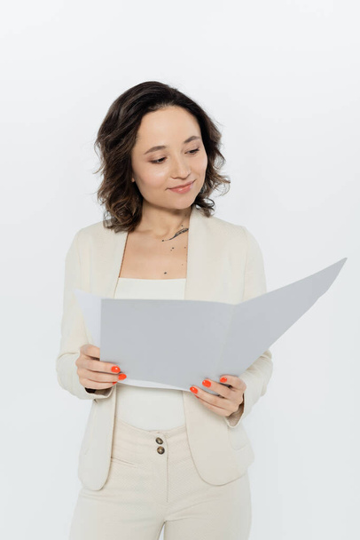 Brunette businesswoman holding paper folder isolated on grey  - Φωτογραφία, εικόνα