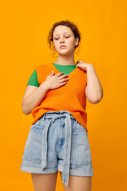 cute girl in orange sweater posing summer style - Foto, Imagen
