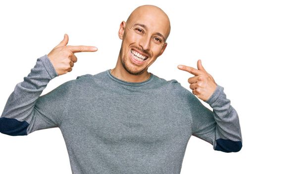 Bald man with beard wearing casual clothes smiling cheerful showing and pointing with fingers teeth and mouth. dental health concept.  - Photo, Image
