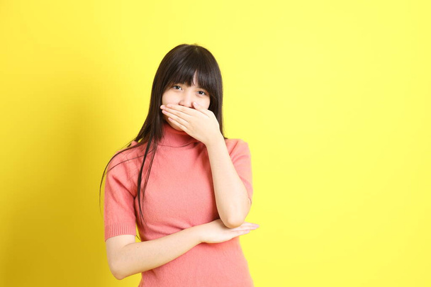 The teen Asian girl with casual dressed standing on the yellow background. - Fotoğraf, Görsel
