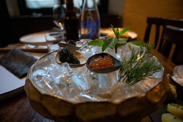 Fine Russian caviar served on ice with thyme leaves in a Soviet restaurant - Photo, Image