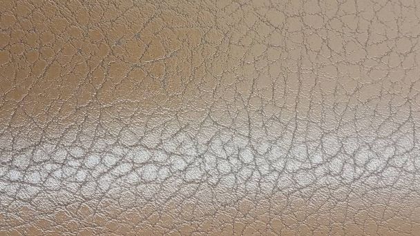 Shiny beige leather background close-up. Beige Glossy Texture Of Artificial Leather. - Photo, Image