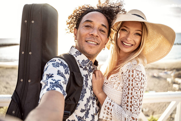Portrait Of beautiful happy multiracial couple having fun together on the beach. Leisure time. Summer. Real people emotions. - Fotografie, Obrázek