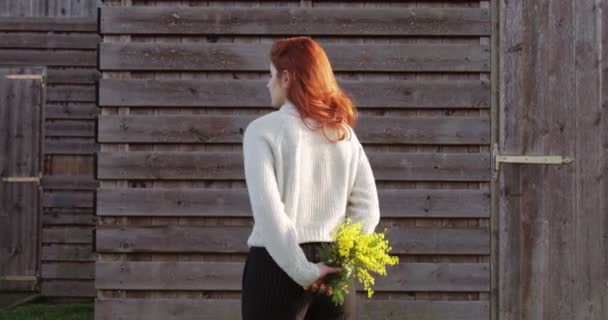 Chica joven se da la vuelta y muestra un hermoso ramo de mimosas amarillas  - Imágenes, Vídeo