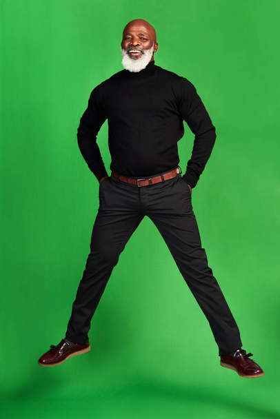 Never stop living your best life. Studio shot of a senior man posing against a green background. - Фото, изображение