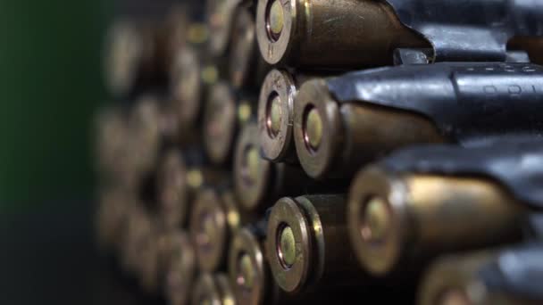 Cartridges from a machine gun on a black background. - Footage, Video