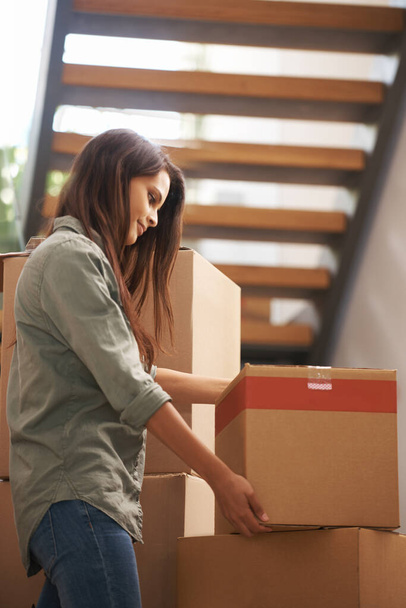 Moving to my new apartment. Young woman setting a box down. - Photo, Image