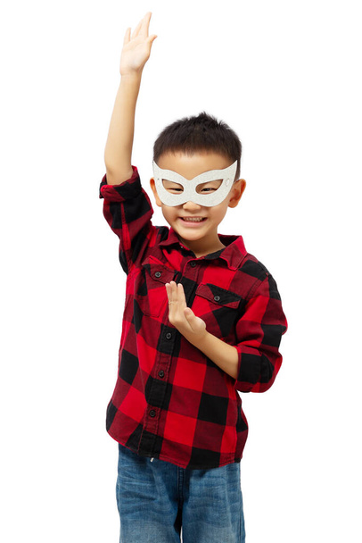 Happy kid playing superhero wearing red shirt and eye mask isolated on white background - Photo, Image