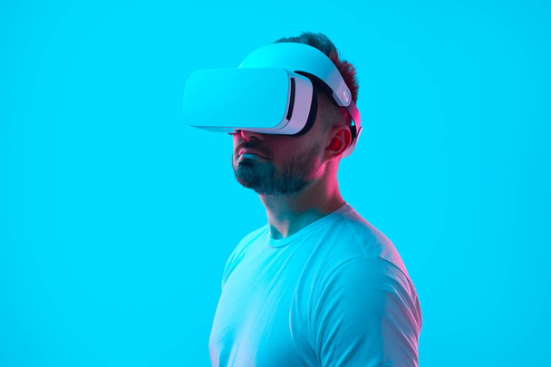 Man experiencing virtual reality in headset - Photo, image