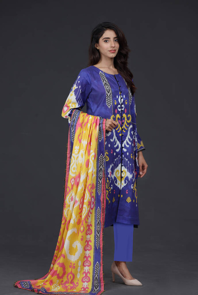 A Pakistani shalwar kameez suit with dupatta. Pakistani model is shown her dress with style. - Foto, imagen