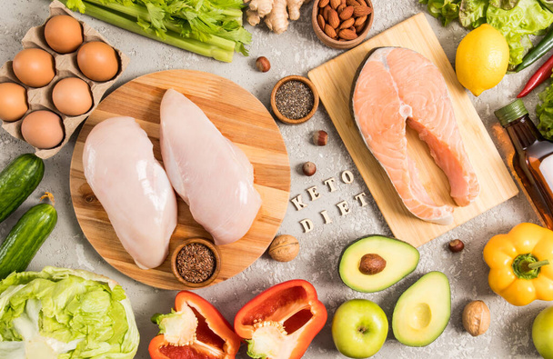 top view of the keto or ketogenic diet on a gray background. a set of healthy foods with a high protein content and a good source of fat - Foto, imagen