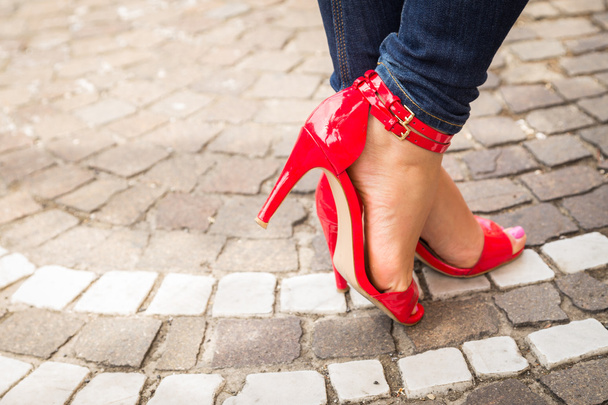 Жіночі ноги в червоних туфлях на високих підборах
 - Фото, зображення