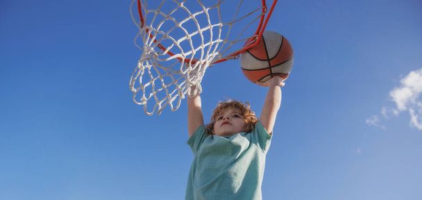 Basketball kids training game. Basketball school for little child boy. Banner isolated on sky background. - Photo, Image