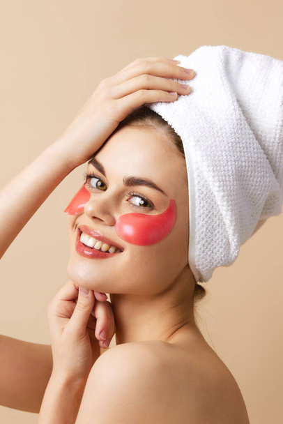 woman pink patches on the face with a towel on the head isolated background - Φωτογραφία, εικόνα