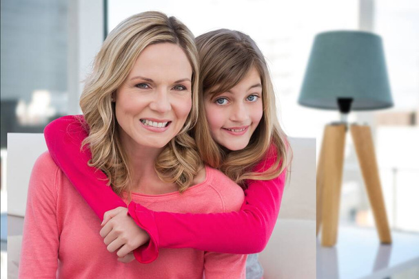 Composite image of caucasian mother and daughter smiling against house interior in background. motherhood and love concept - Foto, Imagem