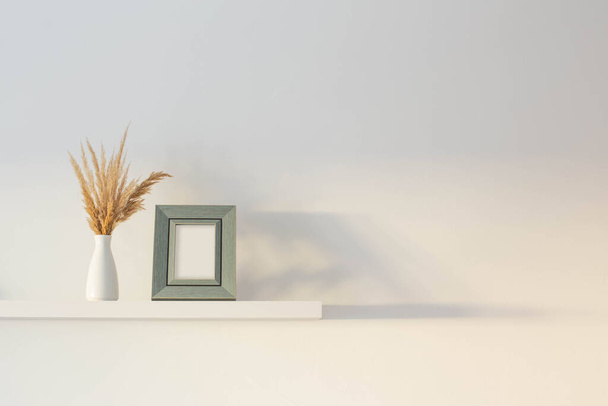 wooden frame with dried flowers in vase  on background white wall - Foto, Bild