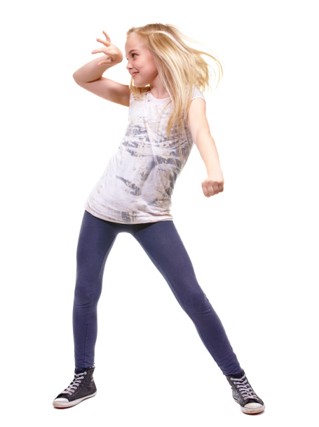 Lets party. Full length shot a young girl dancing against white background. - Фото, изображение