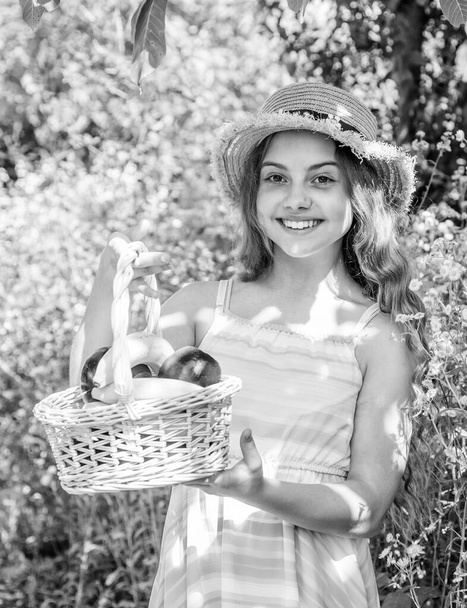 Eat healthy. Cute girl child with basket fruits nature background - Photo, Image