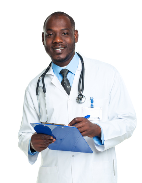 Portrait of a smiling male doctor writing in the notepad on whit - Photo, Image