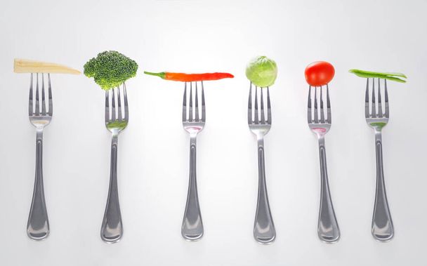 Mouthful de bondade. Uma série de garfos com bocados saudáveis de vegetais sobre eles. - Foto, Imagem