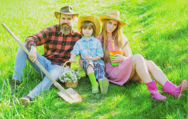 Family gardener in garden or park with shovel. Parenthood together leisure concept. - Photo, Image