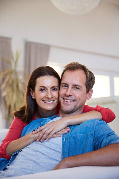 Quality couple time. Portrait of a mature couple relaxing together at home. - Foto, imagen