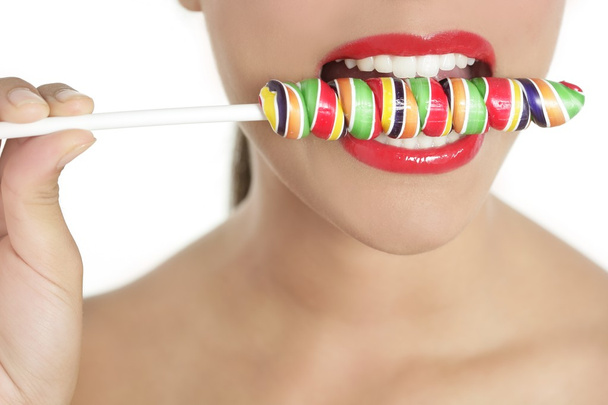 Colorful Lollypop in perfect woman teeth - Foto, Imagen