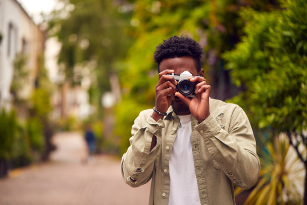 Young Man In City Taking Photo On Digital Camera To Post To Social Media - Foto, Imagen
