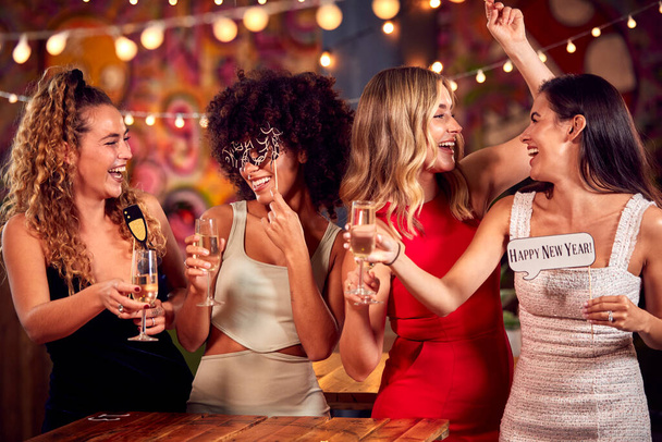 Multi-Cultural Group Of Female Friends Celebrating At 2022 New Year Party Night Out In Bar - Fotó, kép