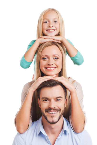 Family of three leaning at each other head - Фото, изображение