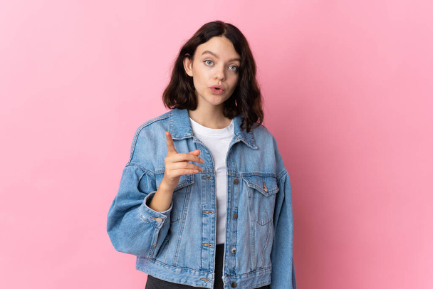 Teenager Ukrainian girl isolated on pink background intending to realizes the solution while lifting a finger up - Photo, Image