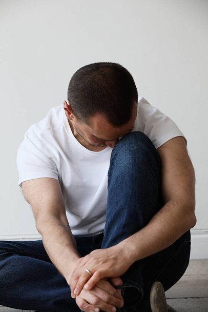 Depressed mature man sitting on floor. Mental issues. Psychology. - Фото, изображение
