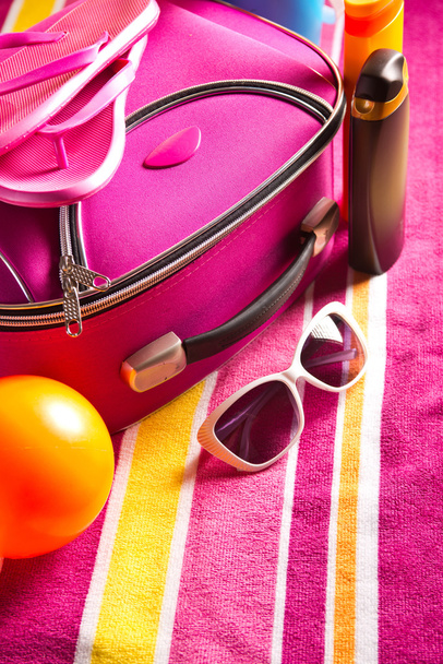 Striped colorful towel with pink bag - Foto, imagen