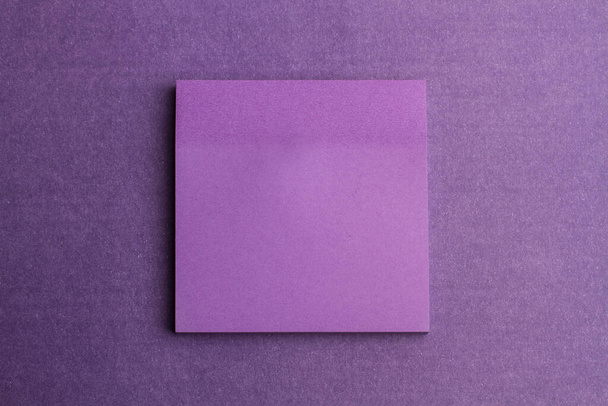 A purple square paper on a purple background with copy space - Foto, Imagen