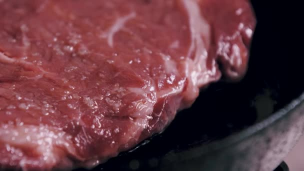 Cocinar bistec de ribeye en una sartén de hierro fundido - Imágenes, Vídeo
