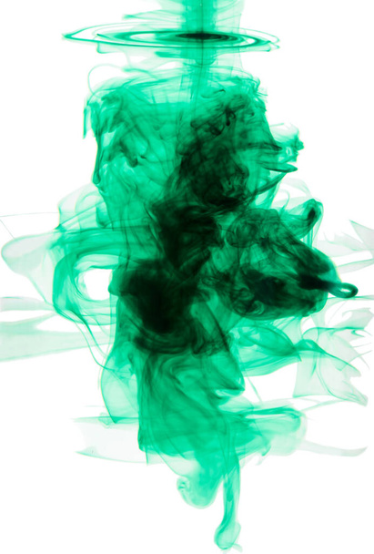 Brilliant green color explosion. Studio shot of green ink in water against a white background. - Фото, изображение