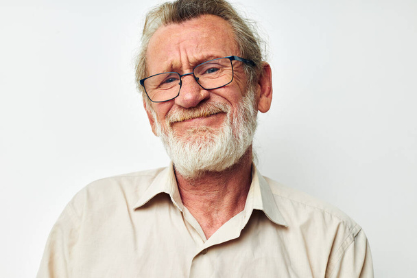 Portrait of happy senior man with a gray beard in a shirt and glasses isolated background - Photo, Image