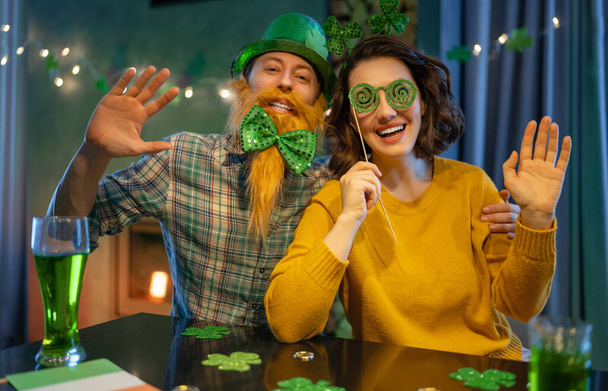 Happy family couple celebrating St. Patrick's Day. - Фото, изображение