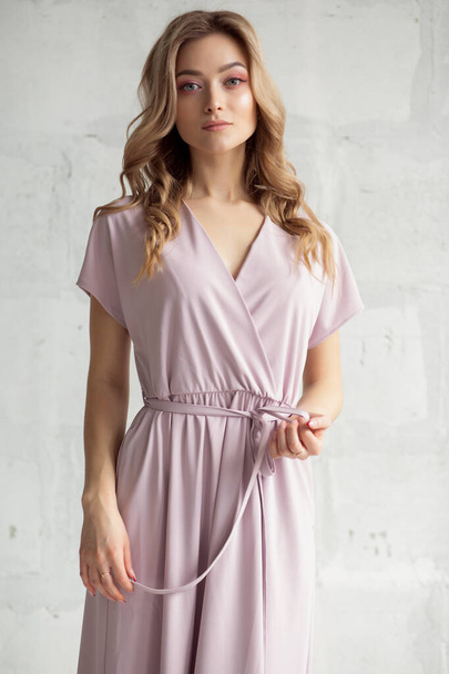 portrait of a sexy blonde beauty in a light elegant pink dress - Photo, image
