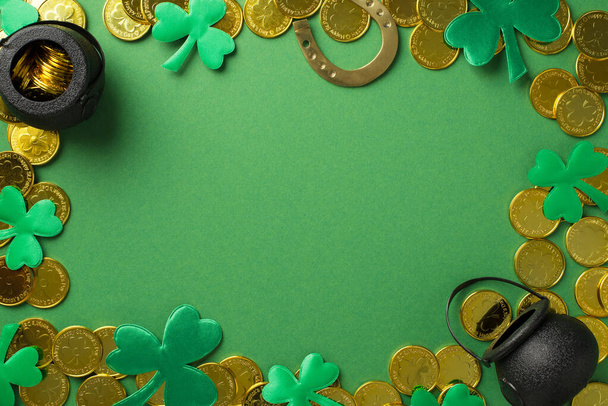 Top view photo of many golden coins two black pots with money inside bronze horseshoe and confetti in shape of clovers different size on the green isolated background copyspace - Photo, Image