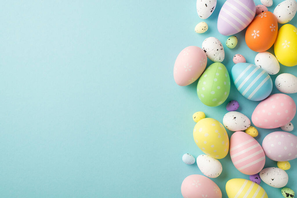 Top view photo of easter decorations multicolored easter eggs on isolated pastel blue background with copyspace - Photo, Image