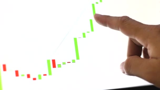 Finger pointing at a bitcoin graph on a computer monitor. - Footage, Video