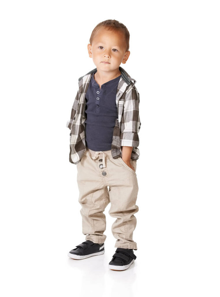 What a cute kid. A little boy standing with his hands in his pockets. - Foto, afbeelding