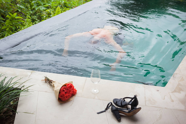 Man swimming after wild party to get rid of hangover. - Foto, immagini